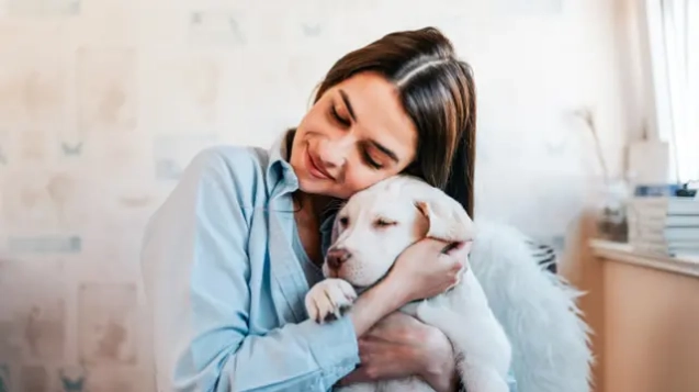 065007700_1592288313-beautiful-brunette-girl-hugging-her-puppy-home-close-up_109710-2512